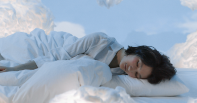 woman asleep surrounded by fluffy clouds