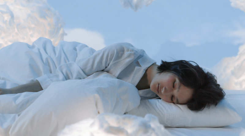 woman asleep surrounded by fluffy clouds
