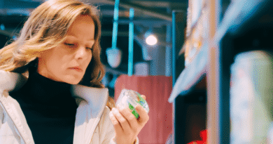 woman looking at a product label in the supermarket