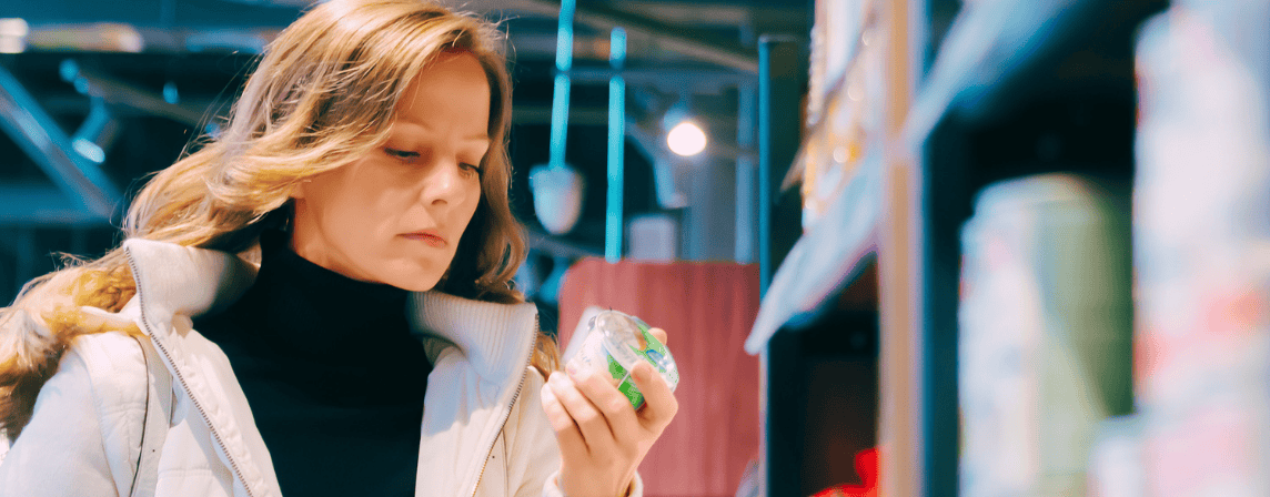 woman looking at a product label in the supermarket