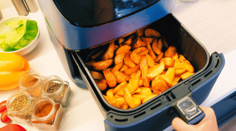 air fryer in a kitchen filled with potato wedges