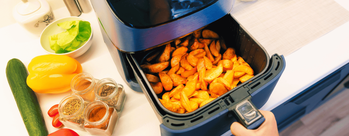 air fryer in a kitchen filled with potato wedges