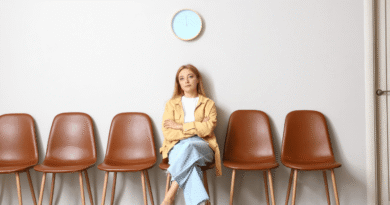 woman sitting alone in waiting room with brown chairs